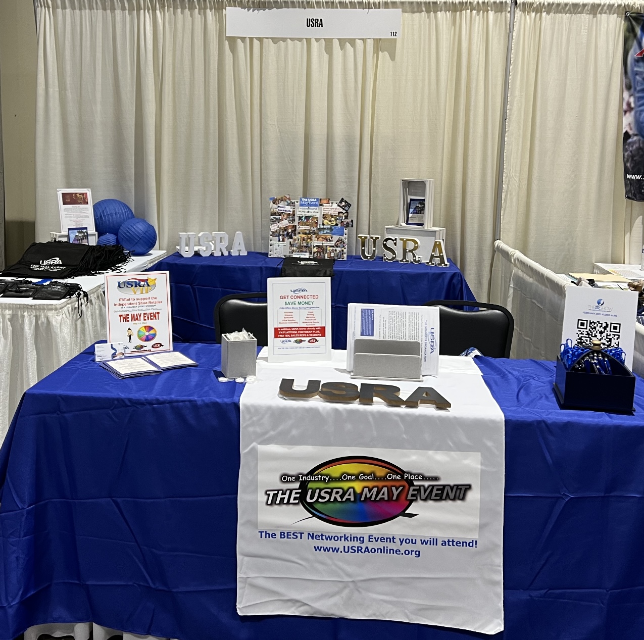 usra, blue table cloth on a table with company flyers at a trade show