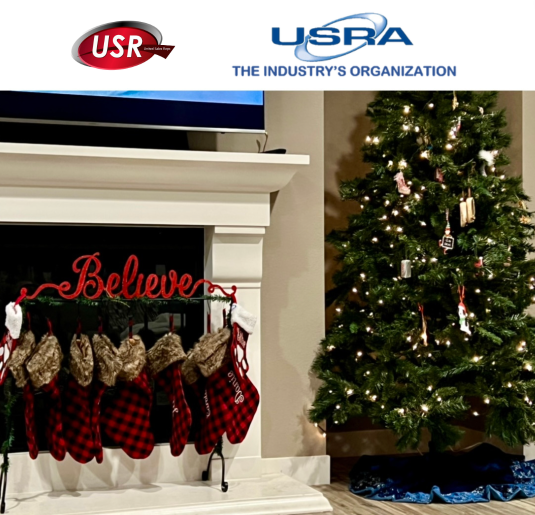 usra, christmas eve pic of stockings in front of the fireplace with Believe sign next to a Xmas tree, USRA & USR Logos