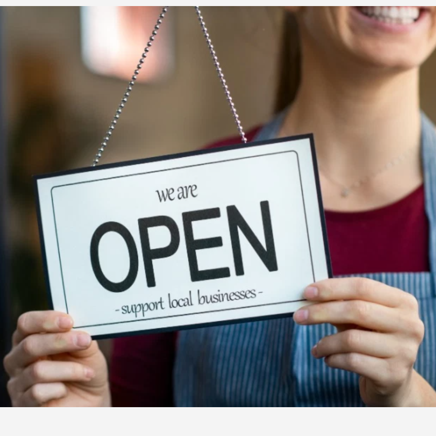 Hands holding yes we are open sign