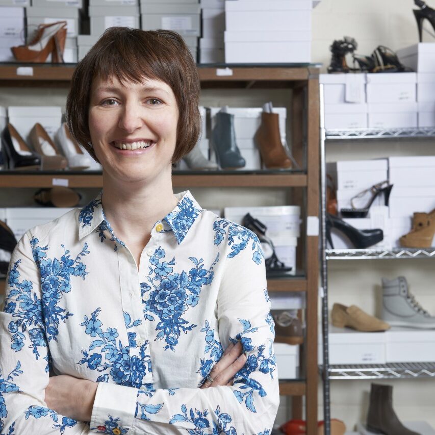 woman standing in small shoe store